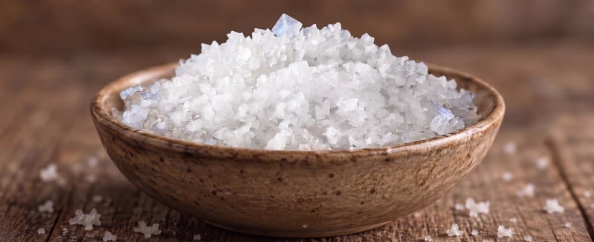 A wooden bowl of Fleur de Sel flakes